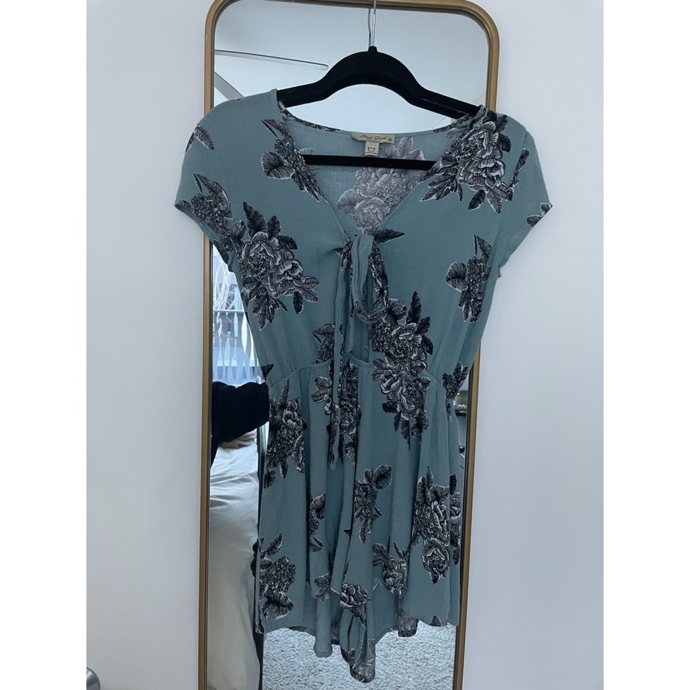 Light blue romper with black and white floral pattern